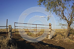 Rustic farm gate and hay bales