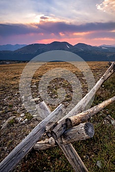 A rustic fence high in the Rocky Mountains at sunset