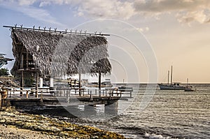 Rustic fishing pier in Curacao at sunset photo