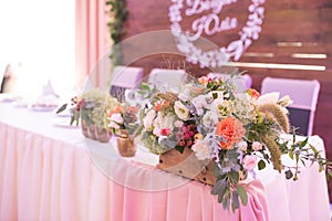 Rustic flower arrangement at a wedding banquet. Table set for an event party or wedding reception.