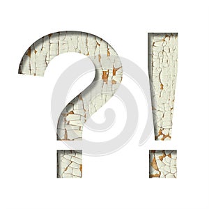 Rustic font. Exclamation and question marks cut out of paper on the background of old rustic wall with peeling paint and cracks.