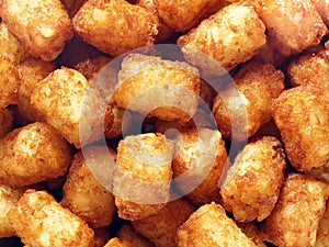 Rustic golden potato tater tots food background photo