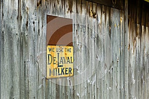 Rustic grey barn siding with metal signs.