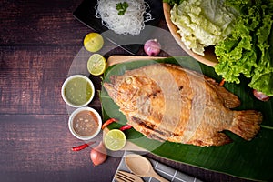 Rustic grilled fish on kitchen table, traditional Thai food