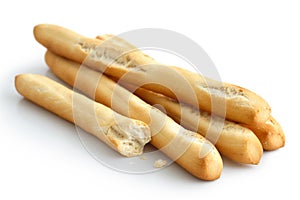 Rustic grissini bread sticks. Isolated on white. Broken with crumbs.