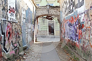 Rustic street art alleyway in Uzupio, a district in Vilnius, Lithuania photo