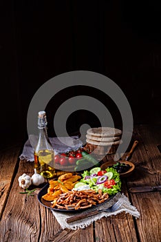 Rustic gyros plate it green salad and potato wedges