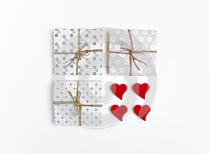 Rustic handmade gift boxes decorated with hearts on white background. Top view, flat lay