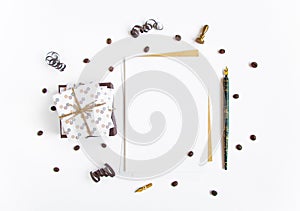 Rustic handmade gifts and a letter on white background decorated with serpentine and coffee beans. Top view, flat lay