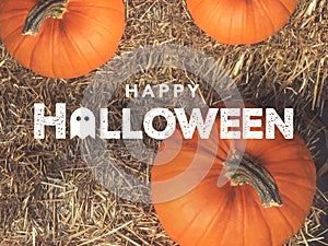 Rustic Happy Halloween Text With Ghost Icon Over Pumpkins and Hay From Directly Above photo