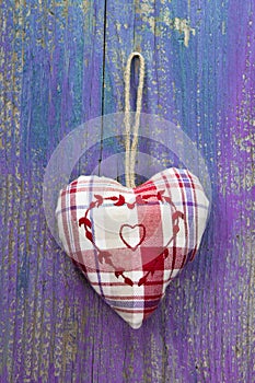 Rustic heart on purple wooden surface for wedding, birthday, val