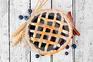 Rustic homemade blueberry pie. Top view over white wood.