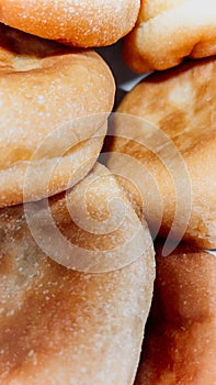 Rustic homemade bread buns stacked on top of each other