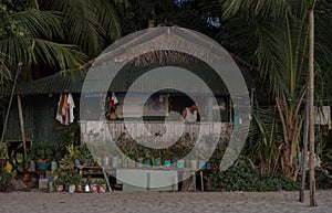 Rustic house on beach and palms background, philippines, port barton