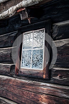 Rustic house with snowflakes on window