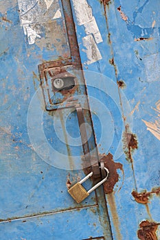 Rustic iron door with closed padlock