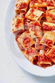 Rustic italian paccheri pasta in tomato sauce