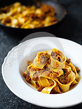 Rustic italian pappardelle bolognese pasta in meat sauce