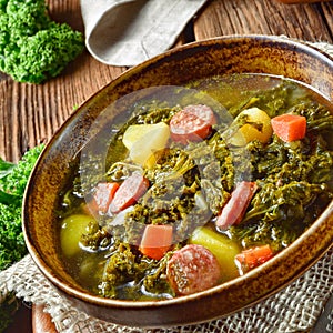 Rustic kale soup with meat and sausage
