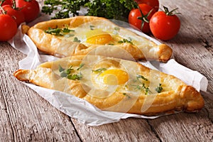 Rustic khachapuri and fresh vegetables close-up. horizontal