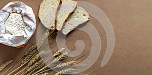 Rustic kitchen or bakery background with flour, bread and wheat spikelets