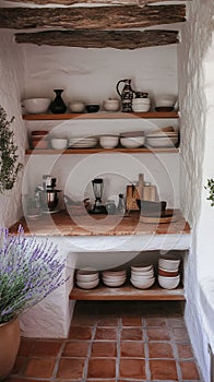 A rustic kitchen with open shelving terracotta flooring and lavender decor.
