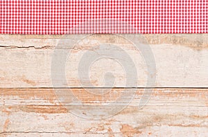 Rustic kitchen table background with red checked tablecloth