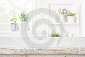 Rustic kitchen table top in front of blurred interior background