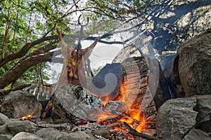 Rustic lamb barbecue bbq over open fire in Patagonia, Argentina, South America.