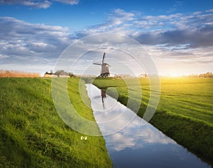 Rustic landscape with dutch windmills near the water canals