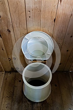 Rustic Latrine with hole in toilet in the middle of the woods, Gatineau Park ,Quebec, Canada