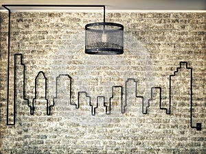 Rustic light kit accented wall of a city skyline on a brick wall background.