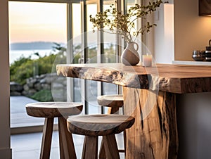 Rustic live edge dining table and solid wood stools close up. Organic interior design of modern living room in farmhouse