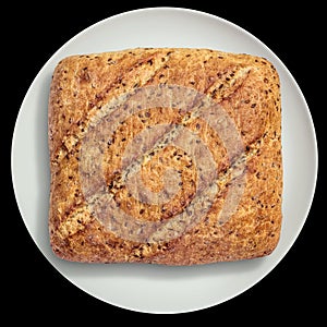 Rustic Multigrain Bread Loaf on White Ceramic Platter Isolated on Black Background