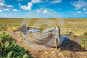 Rustic old boat left to decay on Salt Marshes between Blakeney and Cley