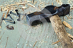 Rustic old hammer on wooden background