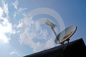 Rustic old parabolic satellite station and blue sky