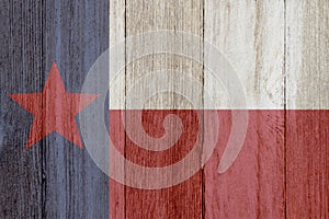 A rustic old Texas flag on weathered wood