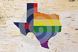 A rustic old Texas pride flag with state map on weathered wood