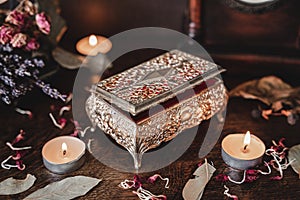 Rustic old vintage jewelry box on witch`s altar photo