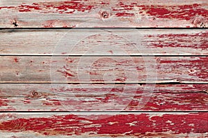 Rustic old weathered wood plank background with flaking red paint photo