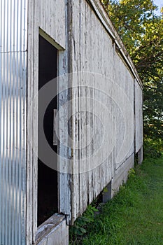 Rustic old wooden door on a deteriorating shed wall