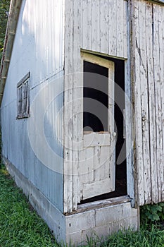 Rustic old wooden door on a deteriorating shed wall