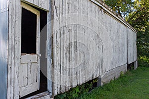 Rustic old wooden door on a deteriorating shed wall