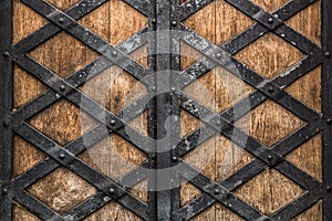 Rustic old wooden doors with a forged metal texture background