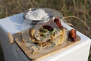 Rustic omelet on a cutting board and steamed rice.