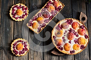 Rustic open pie with peach and raspberry, french galette . Peach tart. Raspberry tart. Tartalette with cream. Variety of bakery.