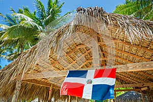 Rustic palapa thatched roof with Dominican Republic Flag in Punta Cana