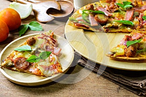 Rustic pizza with becon, salami, mozzarella and basil