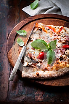 Rustic pizza topped with fresh basil photo